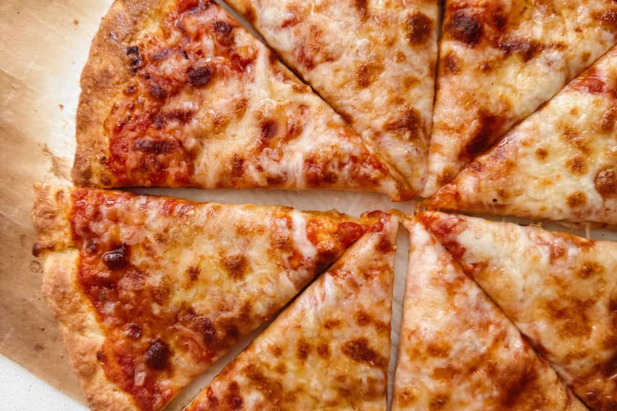 Close-up of a cottage cheese crust pizza, served on a wooden cutting board.