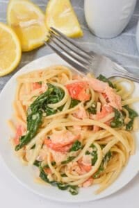 A heaping serving of the salmon pasta on a white dish.