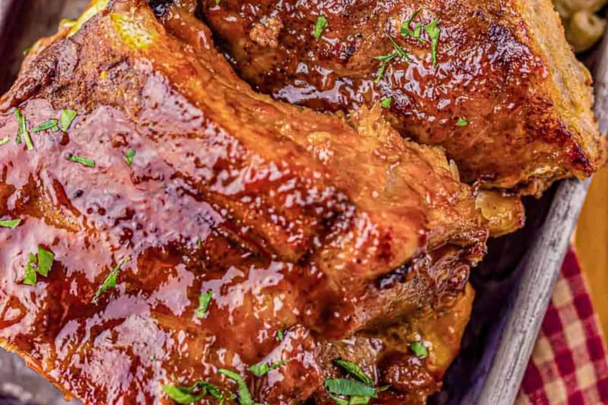 A close-up of some slow cooker Dr Pepper ribs, served on a metal tray.