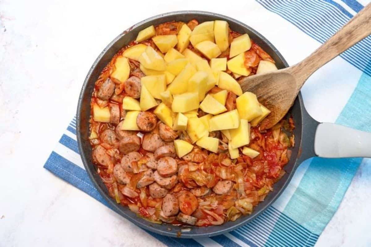 Savory kielbasa sausage and sautéed cabbage cooked together in a skillet.