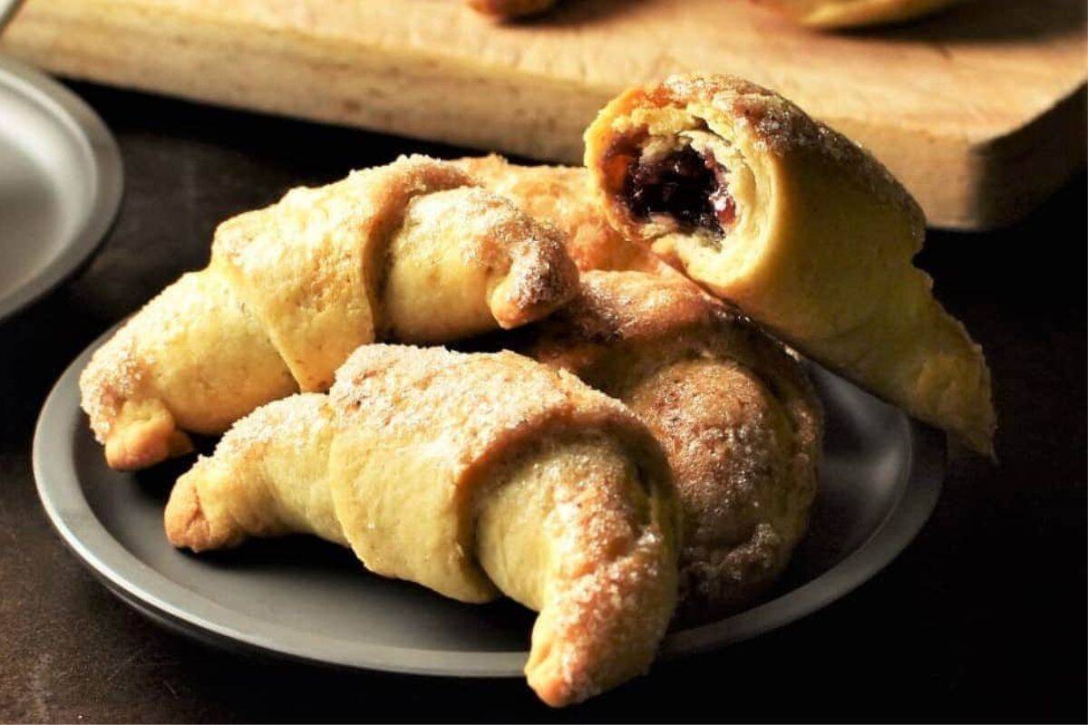 Buttery, crescent-shaped Polish Rogaliki cookies filled with fruit preserves or nuts.