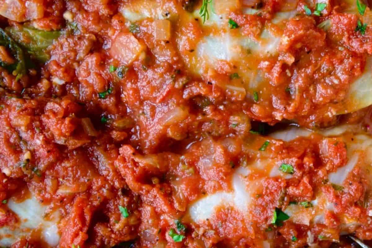 cabbage rolls stuffed with seasoned meat and rice, baked in a savory tomato sauce.