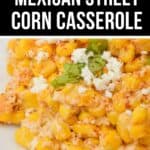 Close-up of a plate of creamy Mexican Street Corn Casserole, topped with white cheese, chopped cilantro, and sprinkled spices.