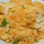 A plate topped with a golden, crunchy breadcrumb crust and garnished with fresh parsley.