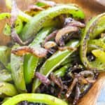 A close up of the vegetables served in a rustic wooden dish.
