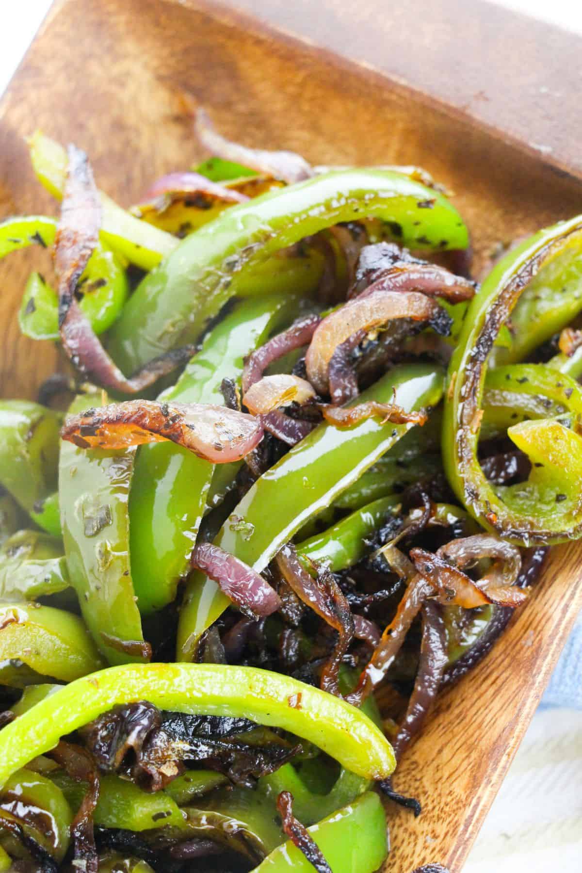 A close up of the vegetables served in a rustic wooden dish.
