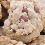 Close-up of several soft chocolate chip cookies with a rough, crumbly texture and visible chocolate chips.