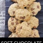 A pile of Soft Chocolate Chip Cookies arranged on a dark wooden surface, with part of a newspaper visible in the background. Text below reads: "Soft Chocolate Chip Cookies.