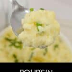 A spoonful of Boursin Mashed Potatoes garnished with chopped chives, with a bowl of creamy Boursin Mashed Potatoes in the background. Text reads: "Boursin Mashed Potatoes.