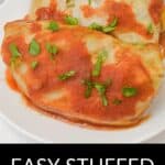 Two Easy Stuffed Cabbage Rolls topped with tomato sauce and chopped parsley are served on a white plate.