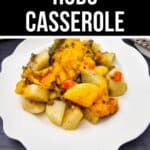 A serving of Hobo Casserole with potatoes, ground meat, vegetables, and melted cheese on a white plate.