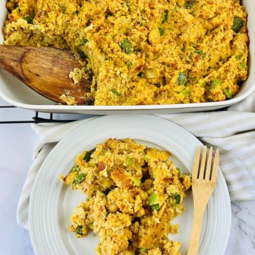 A baking dish of cornbread stuffing with a wooden spoon, and a serving on a white plate with a wooden fork.