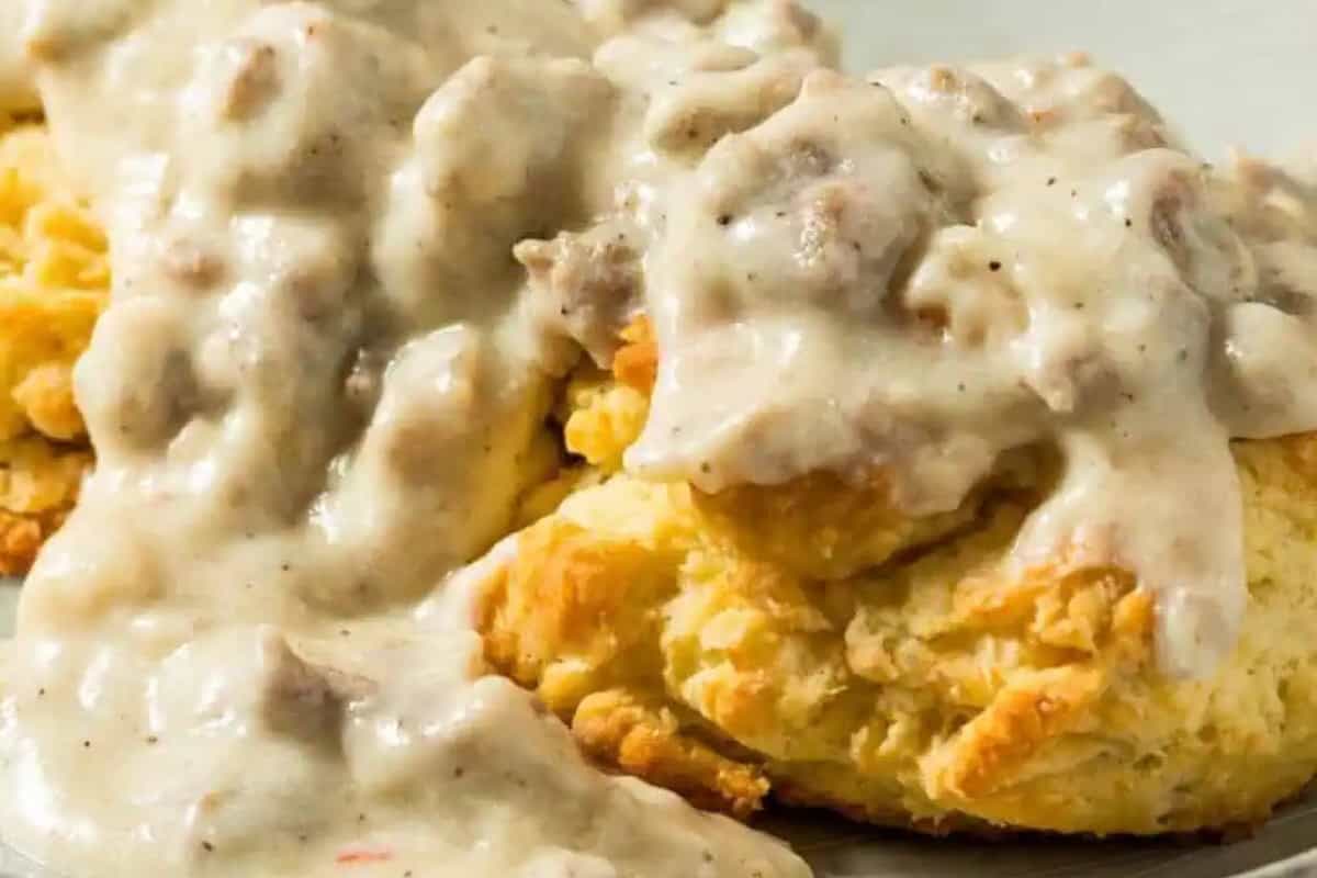 A biscuit topped with creamy sausage gravy, this classic breakfast recipe features a thick, chunky sauce poured over a golden, cheesy, flaky biscuit.
