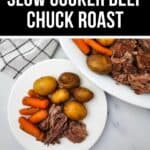 A plate with Slow Cooker Beef Chuck Roast, potatoes, and carrots sits next to a larger serving platter with more of the same food on a white surface.
