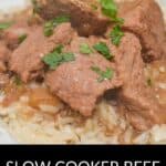 Chunks of beef with brown gravy served over rice, garnished with chopped parsley, on a white plate. Text reads: "Slow Cooker Beef Tips and Gravy—a comforting classic made easy in your slow cooker.