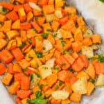 Vegetables arranged on parchment paper, are beautifully garnished with fresh chopped parsley.
