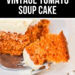 A slice of Vintage Tomato Soup Cake with white frosting sits on a white plate, while a fork holds a piece of the nostalgic cake.