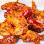 A plate of saucy baked chicken wings garnished with herbs, placed on a white plate, highlights the effortless magic of Automatic Cooking, with the text “Low Effort Slow Cooker Recipes” at the bottom.
