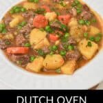 A white bowl filled with Dutch Oven Beef Stew, featuring tender chunks of beef, potatoes, carrots, peas, and fresh herbs. Text at the bottom reads "Dutch Oven Beef Stew.