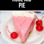 A slice of Kool Aid Pie with whipped cream and maraschino cherries sits on a white plate.