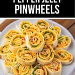 Pepper Jelly Pinwheels made with rolled tortillas are sliced to reveal colorful fillings, then neatly arranged on a white plate for an eye-catching appetizer.