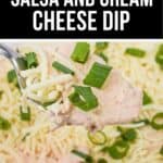 A fork holds a bite of Salsa and Cream Cheese Dip topped with shredded cheese and chopped green onions, while the dish sits invitingly in the background.
