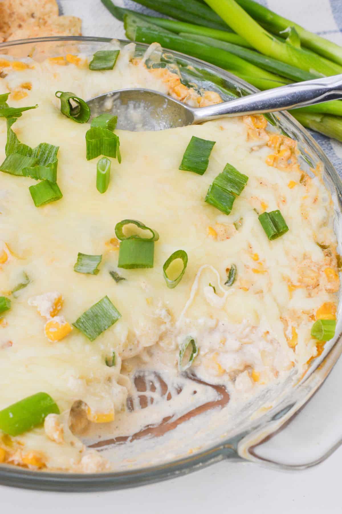 A finished appetizer with spoons in it.