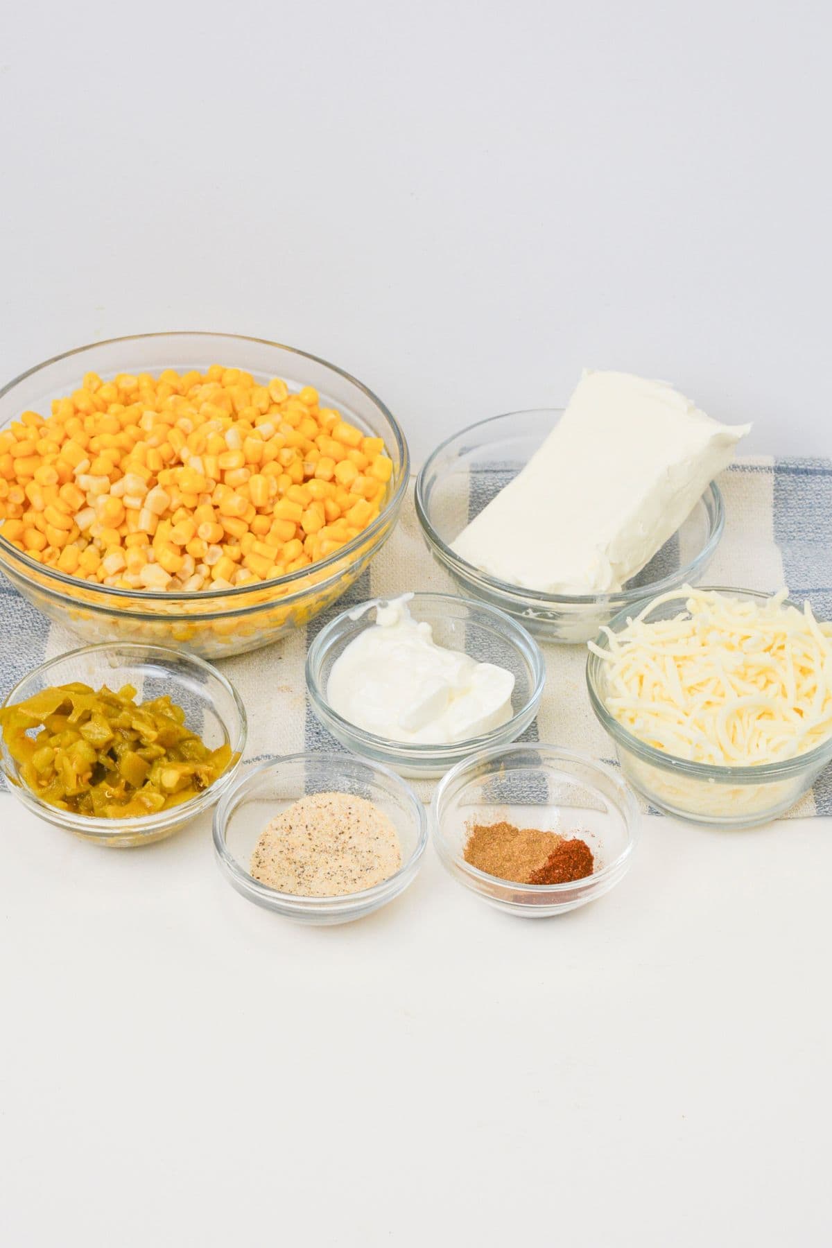 Clear bowls with the vegetables and seasonings to make the appetizer.