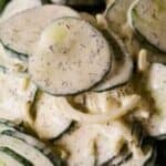 Close-up of creamy cucumber salad with dill, featuring the text “15 Best BBQ Recipes for Summer” overlaid at the bottom of the image—perfect inspiration for anyone searching for refreshing summer recipes and the best BBQ ideas.