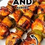 Grilled Chicken Kabobs and vegetable skewers are served on a white plate, with a text overlay reading “Chicken and Kabobs Grilled.”.